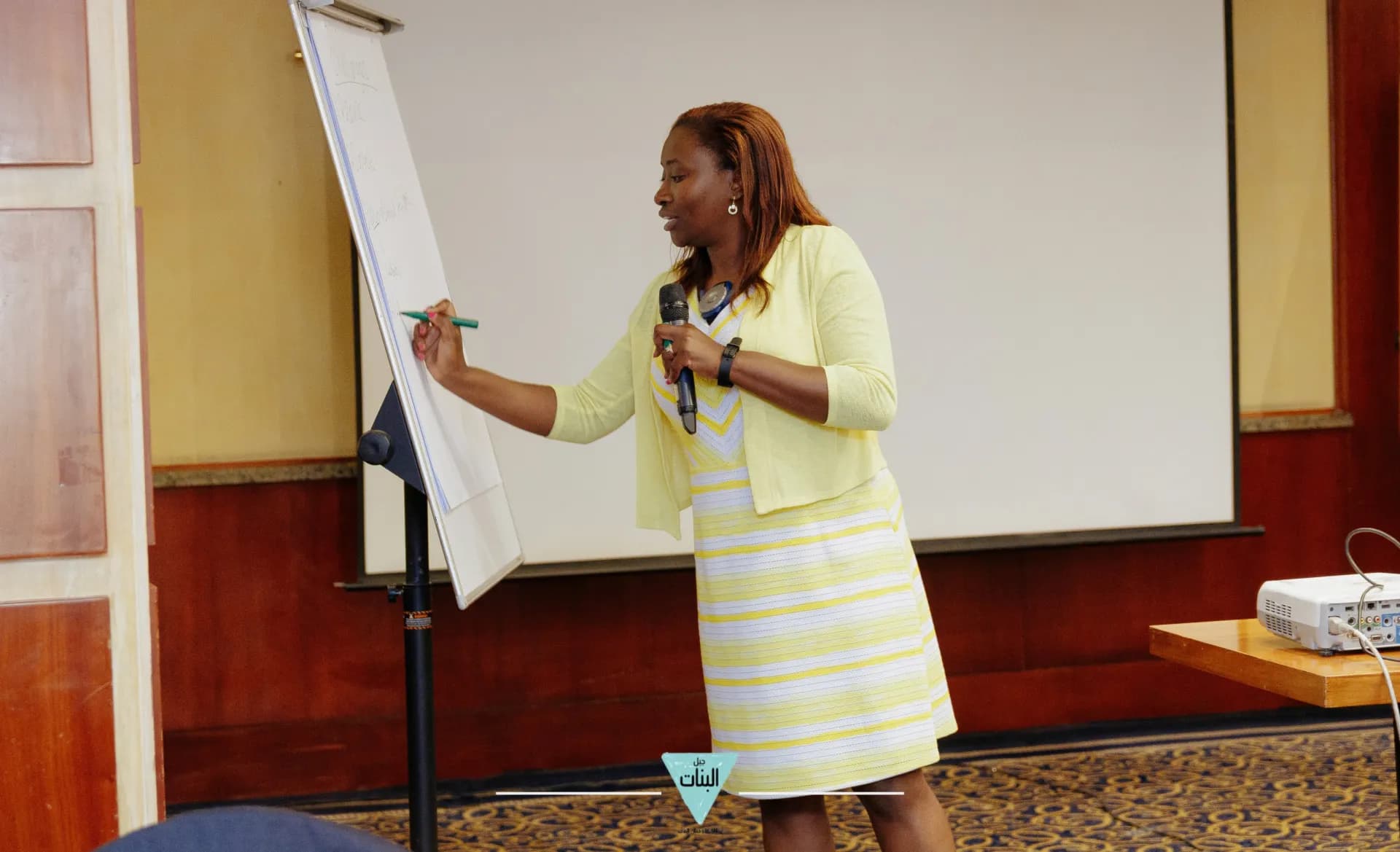 Liza Akinyi speaking at a conference